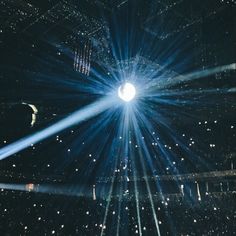 the stage is lit up with bright lights and stars in the air, while people are watching