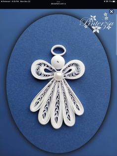 a white angel ornament on a blue background