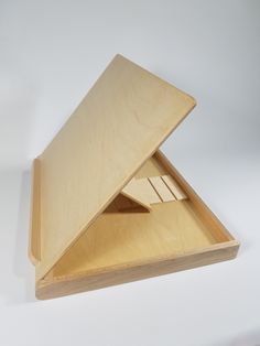 an open wooden box with two pieces of wood in the bottom and one piece missing