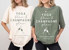 two women wearing yoga and champagne t - shirts