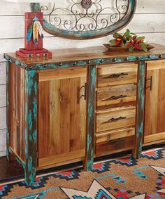 a wooden cabinet with metal handles and drawers in front of a white painted wood wall