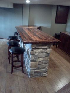 a kitchen island made out of wood and stone