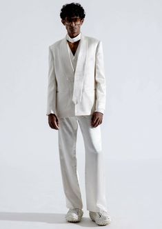 Elevate your style with our alabaster blazer. This classic straight-cut blazer, crafted from high-quality white vegan mashru fabric, is a testament to timeless sophistication and remarkable comfort. The blazer showcases an asymmetrical shawl collar with tie-shaped ends, adding a unique touch of refinement to your ensemble. White Structured Single-button Blazer, White Structured Blazer With Hidden Button Closure, Modern White Single Button Blazer, White Spring Blazer With Pressed Crease, Chic White Blazer With Pressed Crease, Modern White Blazer With Hidden Button Closure, White Structured Business Blazer, Chic White Outerwear With Pressed Crease, Timeless White Blazer With Hidden Buttons