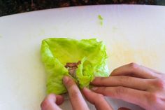 someone is peeling lettuce on a cutting board