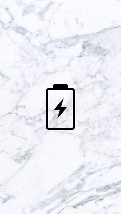 a white marble wall with a black battery icon