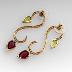 These gorgeous earrings by Stephanie Occhipinti are each accented with thirty-five (35), prong set, round brilliant cut diamonds and feature two (2) dangle settings accented with one (1), bezel set, pear rose cut natural rhodolite garnet and one (1), prong set, pear checkerboard cut natural peridot. The earrings measure 47mm X 14mm and are finished with friction style backs. Elegant Multi-stone Diamond Earrings, Elegant Multi-stone Diamond Earrings For Formal Occasions, Luxury Pierced Chandelier Earrings For Anniversary, Formal Multi-stone Drop Earrings, Formal Multi-stone Teardrop Earrings, Formal Teardrop Multi-stone Earrings, Gold Multi-stone Diamond Earrings, Gold Diamond Multi-stone Earrings, Elegant Multi-stone Round Earrings