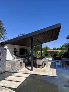 an outdoor kitchen and dining area is shown