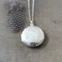 "This vintage sterling silver locket is engraved with a classic swirl design on the front and back. The large round locket opens to revealing two compartments awaiting your favorite photos. The pendant is suspended from a new sterling silver chain adorned with tiny amethyst stones at the clasp. Locket 30 mm Necklace 24\" (61cm) ✦All of our lockets ship with complimentary insurance✦ ✤Our entire selection of lockets can be found here✤ http://www.etsy.com/shop/LexiandGem?section_id=7506972" Elegant Oval Pendant Locket Necklace For Vintage Collection, Elegant Oval Pendant Locket Necklace From Vintage Collection, Elegant Round Etched Necklace, Elegant Round Etched Necklaces, Classic Locket Necklace For Vintage Collection, Classic Silver Locket Necklace, Classic Pendant Necklace With Etched Details, Elegant Filigree Locket Necklace For Wedding, Silver Medallion Necklace With Etched Details