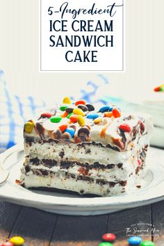 a slice of ice cream sandwich cake on a white plate with colorful candies around it