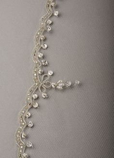 a close up view of the beaded edge of a veil