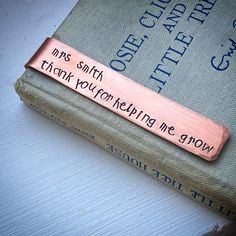 a book with a copper bar that says, miss smith thank you for helping me grow