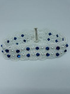 This handmade beautiful bracelet is made of quality materials. It measures 7 1/2 inches, and has a silver slide bar clasp. If you like high fashion you will love this one. Made with navy blue crystals, white pearls, white iridescent seed beads, jewelry line. Elegant Adjustable Blue Bracelets, Elegant Blue Handmade Bracelets, Elegant Formal Bracelet Wristband, Elegant Formal Wristband Bracelet, Elegant Adjustable Blue Beaded Bracelets, Elegant Adjustable Blue Crystal Bracelet, Elegant Handmade Bracelet As A Gift, Elegant Handmade Bangle Wristband, Elegant Silver Bracelet Wristband