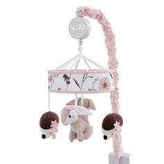 a pink and white baby crib mobile with two stuffed animals