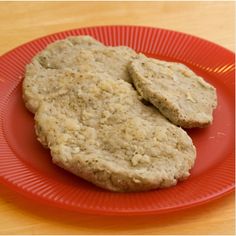 two cookies sitting on top of a red plate