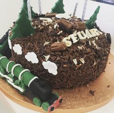 a birthday cake with chocolate frosting and decorations