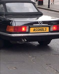 a black car is parked on the street