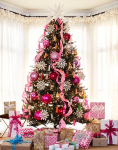 a decorated christmas tree with presents under it