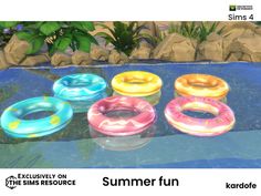 four inflatable swimming rings sitting on top of a pool