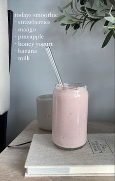 a pink smoothie in a glass with a straw