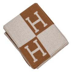 a brown and white towel with the letter h on it