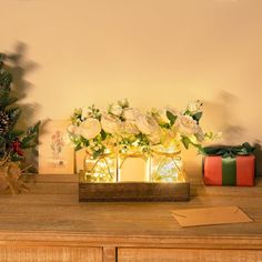 a wooden table topped with flowers and presents