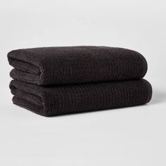 two dark brown towels stacked on top of each other