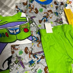 Brand New With Tags. Toys Story Pajama Set. Size 12m Snug-Fitting. 4 Piece. 2 Tops One Pair Of Shorts And One Pair Of Pants. Multicolor Cartoon Print Bedtime Sets, Multicolor Cartoon Print Sets For Playtime, Fun Cartoon Print Bedtime Sets, Cute Green Bedtime Set, Fun Multicolor Bedtime Sets, Playful Green Sets For Sleepover, Playful Green Sets For Sleepovers, Playful Green Sleepover Sets, Mickey Shorts