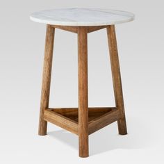 a white marble topped table with wooden legs