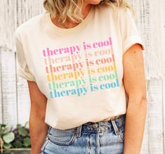 This cute preppy self-care shirt will be the perfect mental health gift for that therapist who loves wearing a kind reminder! Our t-shirts are 100% made in the USA, and we use a high-quality unisex t-shirt that is insanely soft. In fact, it will be one of the softest, best fitting, most comfortable shirts you've ever owned.  ⭐ PREMIUM QUALITY ⭐ ▪️ 100% Cotton ▪️ Made in the USA 👕 SIZING 👕 All our shirts are unisex fit. We always recommend our customers to size up for a stylish oversized look. Therapist Outfit, Therapy Is Cool, Mental Health T Shirts, Positive Tees, Kind Reminder, Kindness Shirts, Love Clothing, Statement Tees