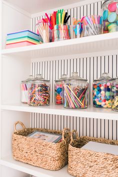 the shelves are organized with baskets and pencils