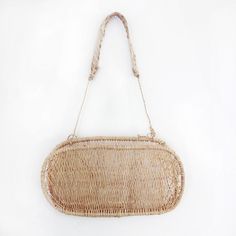 an image of a woven purse on a white background that looks like it could be used as a wall hanging