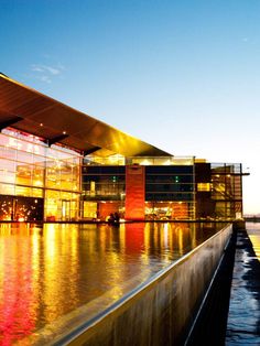 a large building sitting next to a body of water