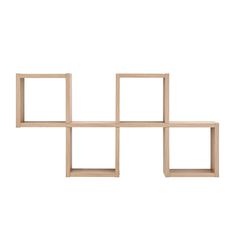 four square wooden shelves are arranged on the wall, one is white and the other is beige