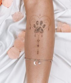 a woman's leg with a tattoo on it and a chain around her ankles