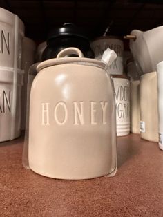 there are many containers on the shelf and one has a canister in front of it