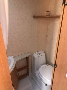 there is a small bathroom with a toilet and sink in the room that has no doors