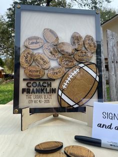 a table topped with lots of wooden magnets next to a sign that says coach franklin