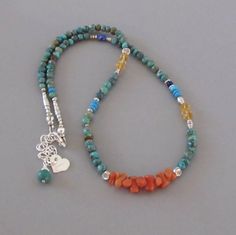 "Beautiful polished American Turquoise, sparkly Citrine, and midnight blue Lapis Lazuli mingled with handmade silver beads surround beautiful vintage Italian Branch Coral. It closes with a lobster claw clasp and has a 2\" extender chain. A Turquoise and a signature heart charm drop from the end of the chain. All metal is .925-.990 sterling and fine silver. Turquoise - approx. 4mm Citrine - approx. 5mm Coral - approx. 7 - 8mm long Length - approx. 17\", extending to approx. 19\" View more items i