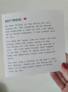 a person holding up a piece of paper with the words best friend written on it