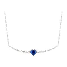 Appearing to float along a strand of diamonds, a vivid blue, heart-shaped sapphire makes an impactful impression in Ri Noor’s Floating Ruby Heart and Diamond Necklace. Round diamonds increase in size towards the central element of the necklace, creating a design that is subtle yet elegant, dazzling yet approachable. The slightly curved horizontal bar is suspended on a simple chain, all set in 18k white gold. Heart-shaped Sapphire Necklace For Formal, Heart-shaped Sapphire Necklace For Formal Occasions, Formal Sapphire Heart Necklace, Elegant Blue Heart Necklace, Fine Jewelry Sapphire Heart Cut Necklace, Blue Sapphire Heart Pendant Necklace, Blue Sapphire Heart Pendant Necklaces, Sapphire Heart Cut Necklace Fine Jewelry, Sapphire Gemstone Necklace For Valentine's Day