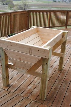 a wooden planter sitting on top of a wooden deck