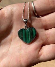 925 Sterling Silver Heart Necklace with Box Chain Malachite is an opaque stone that is a light green to deep green hue. It is found in a unique banded pattern. The bands are white and green and run in parallel streaks. This stone was discovered around 4,000 BC. Malachite translates from Greek to mean mallow, a green leafy herb. Malachite is believed to provide protection to travelers. It has been called the mirror of the soul, because it reflects the inner feelings of a person positive or negati Malachite Necklace, Sterling Silver Heart Necklace, Healing Necklace, Necklace Heart, Pink Necklace, Silver Heart Necklace, Wire Wrapped Necklace, Heart Shape Pendant, Quartz Necklace