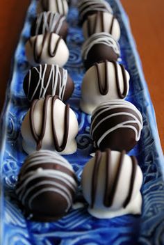 there are many chocolates in the blue boat on the table, ready to be eaten