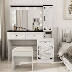 a bedroom with a bed, mirror and dressing table