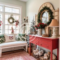 a living room decorated for christmas with wreaths on the windowsill and red furniture