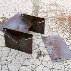 two pieces of metal sitting on the ground