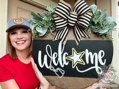 a woman is holding up a welcome sign