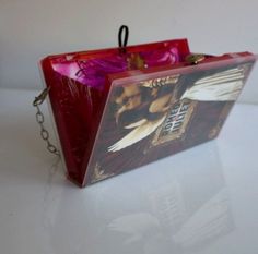 a red purse sitting on top of a white table