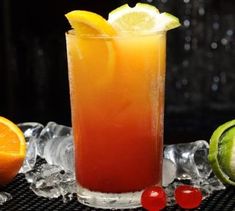 a tall glass filled with an orange and red drink