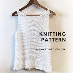 a white knitted top hanging on a wooden hanger with the words knitting pattern written across it